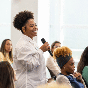 A woman speaking at an event. MONEY and ME: The New Year Reset
